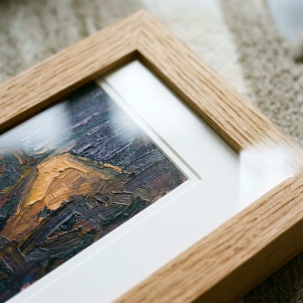 Mitred corner of a natural oak frame with white mount